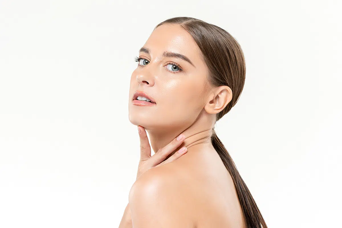 beautiful clear face skin caucasian woman touching her chin and neck