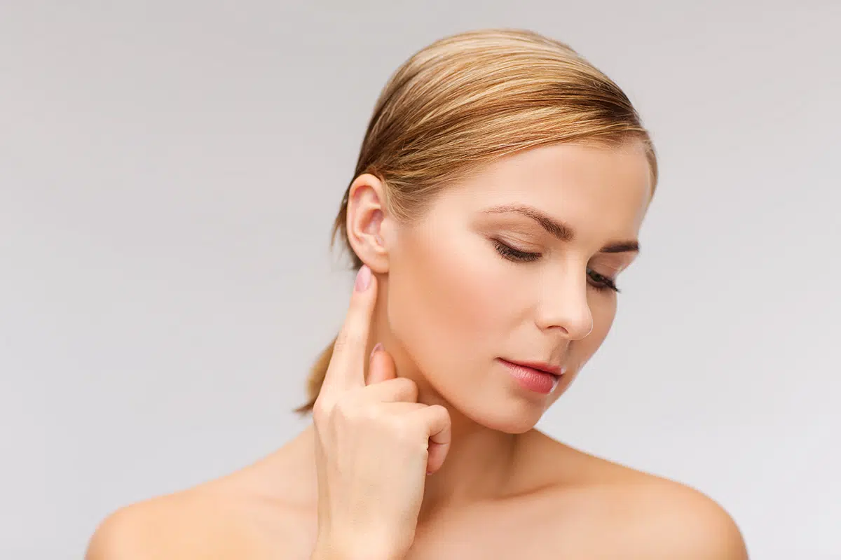 calm woman touching her ear