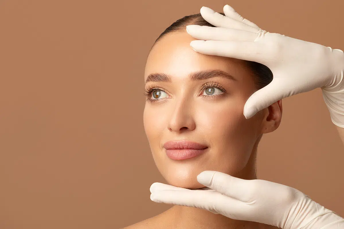 doctor examining young womans face