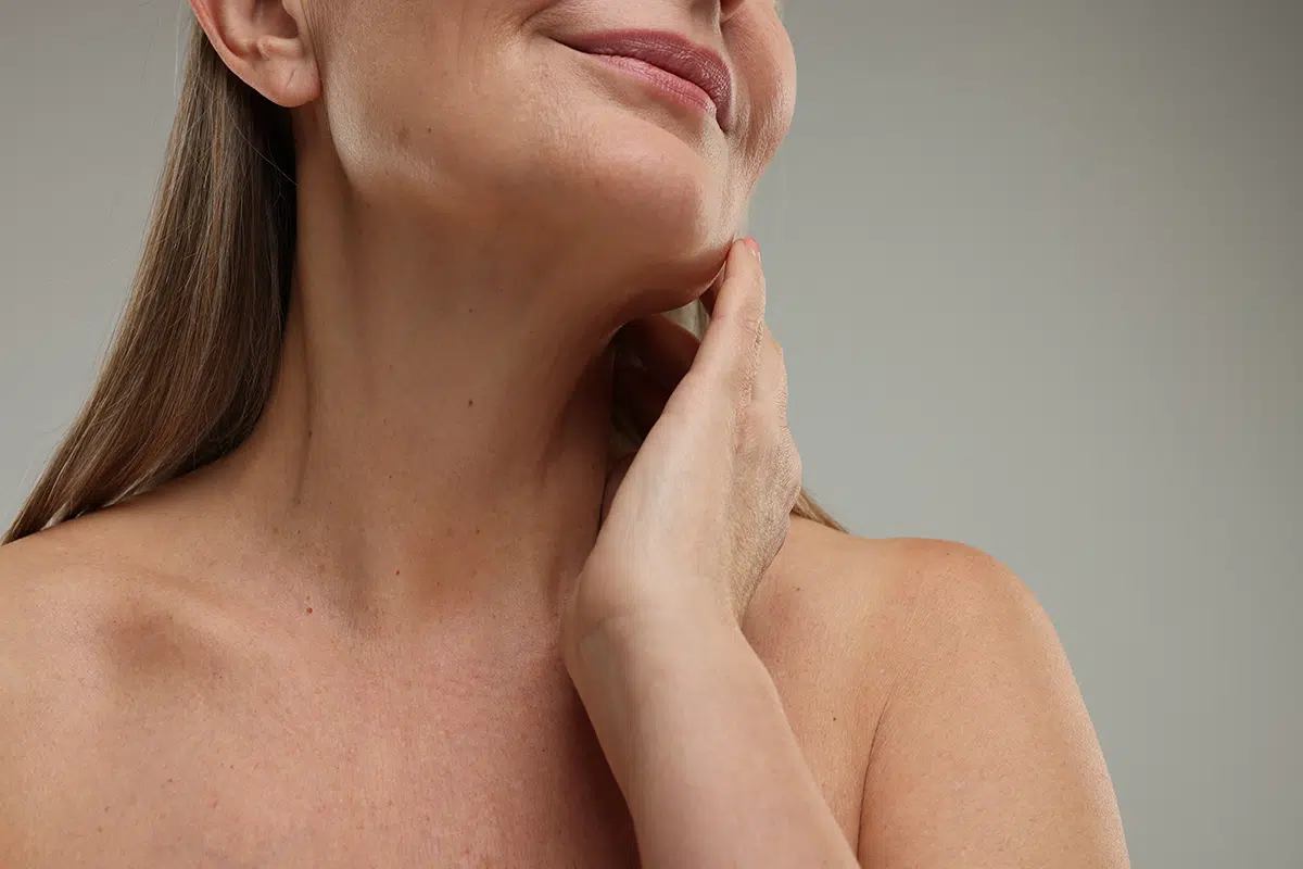 mature woman touching her neck