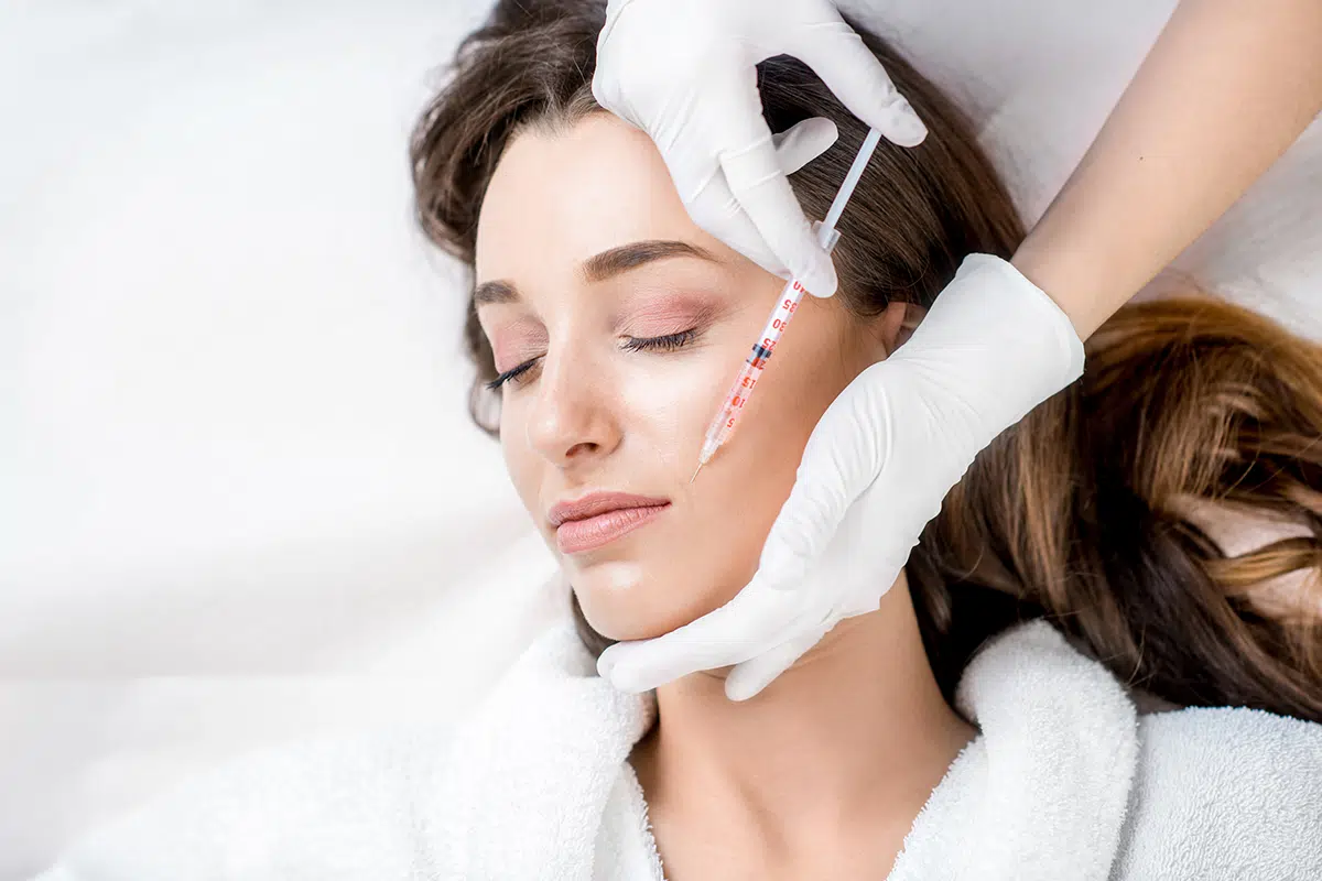 woman receiving cosmetic injection in her face