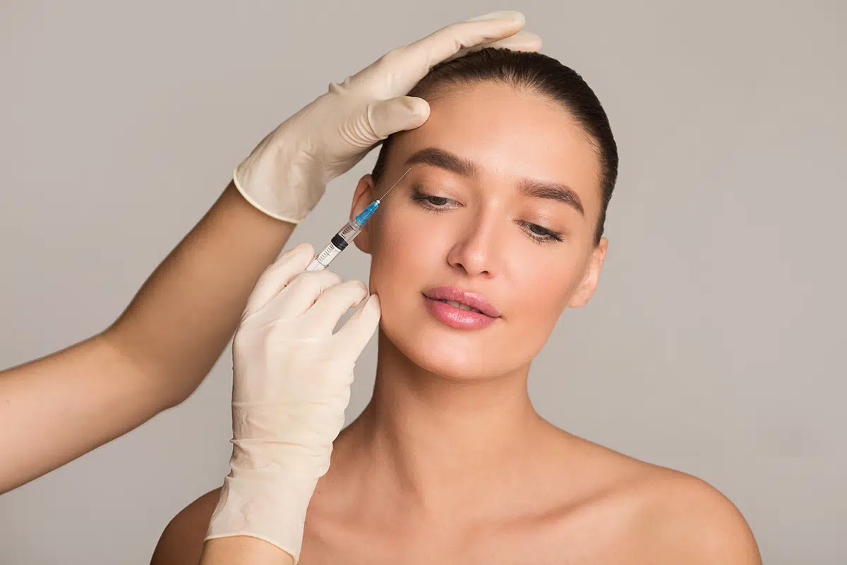 woman with perfect skin receiving botox injection