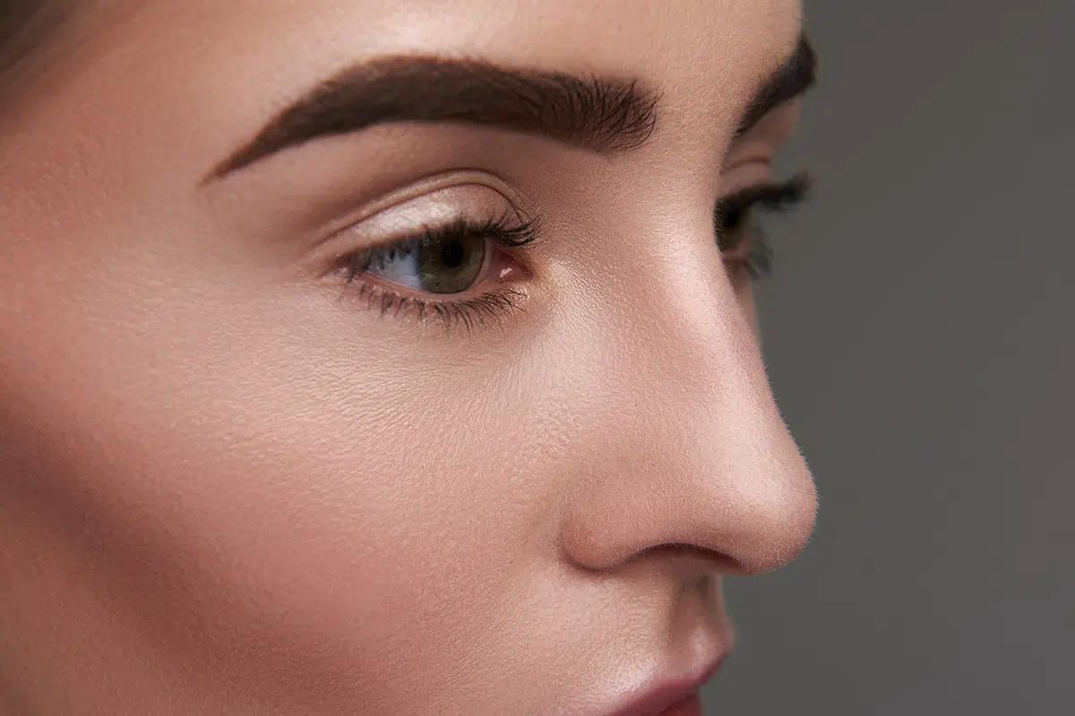 young lady with clean skin and confident glance posing